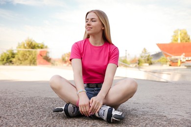 Photo of Happy woman with roller skates on street
