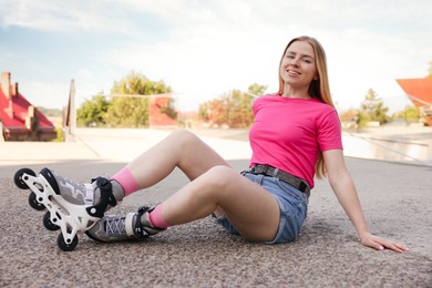 Photo of Happy woman with roller skates on street