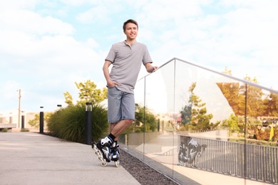 Photo of Happy man roller skating on city street