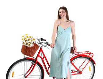 Photo of Smiling woman in dress and bicycle with basket of flowers against white background