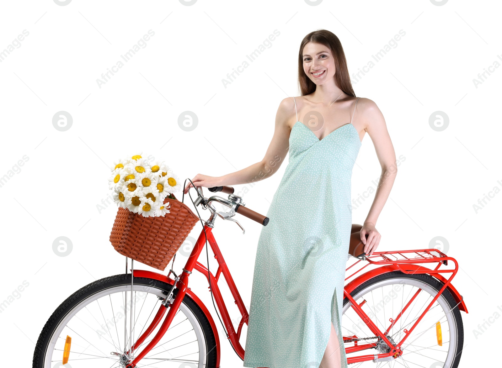 Photo of Smiling woman in dress and bicycle with basket of flowers against white background