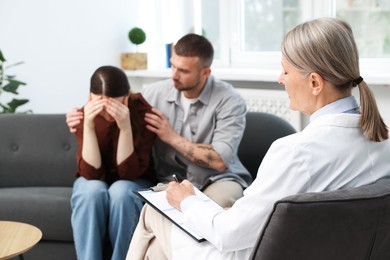 Photo of In vitro fertilization (IVF). Upset couple having consultation with doctor in reproductive clinic