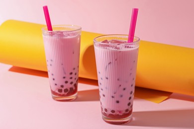Photo of Tasty milk bubble tea in glasses on color background