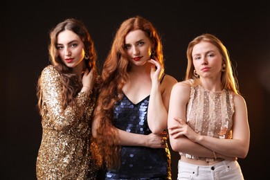 Photo of Beautiful women with different hair colors on dark background