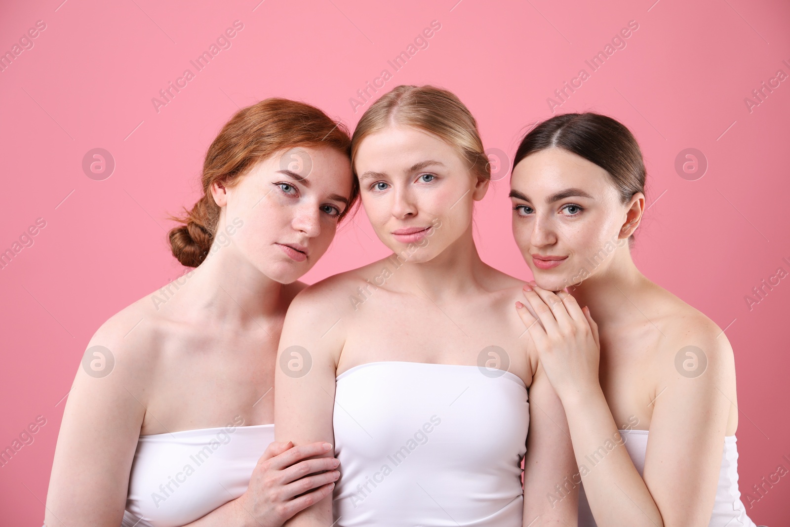 Beautiful women with different hair colors on pink background Photo of Beautiful women with different hair colors on pink background