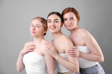 Photo of Beautiful women with different hair colors on grey background