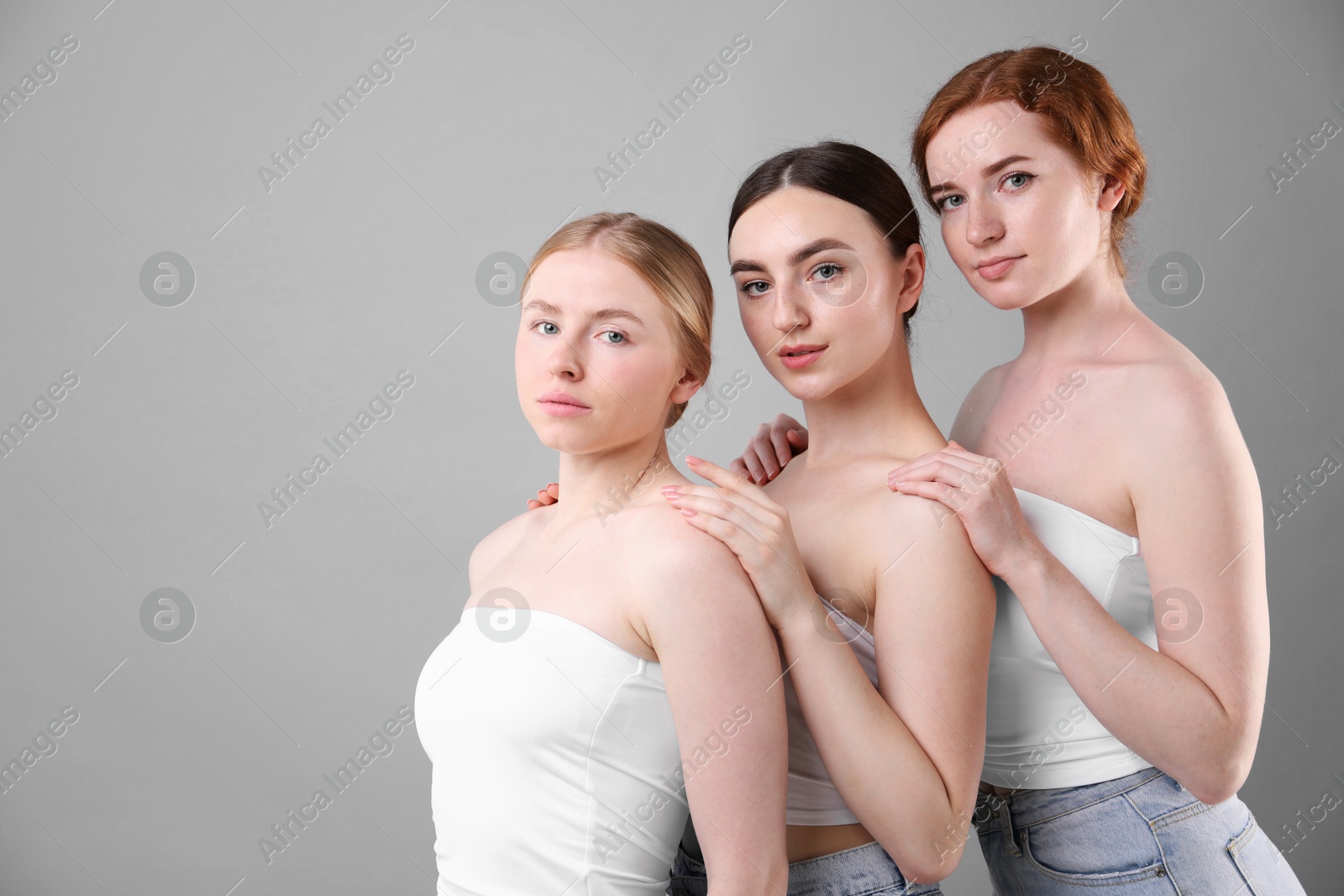 Photo of Beautiful women with different hair colors on grey background, space for text