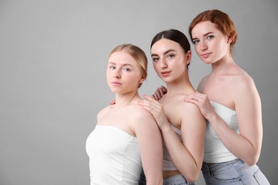 Photo of Beautiful women with different hair colors on grey background, space for text