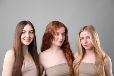 Photo of Beautiful women with different hair colors on grey background