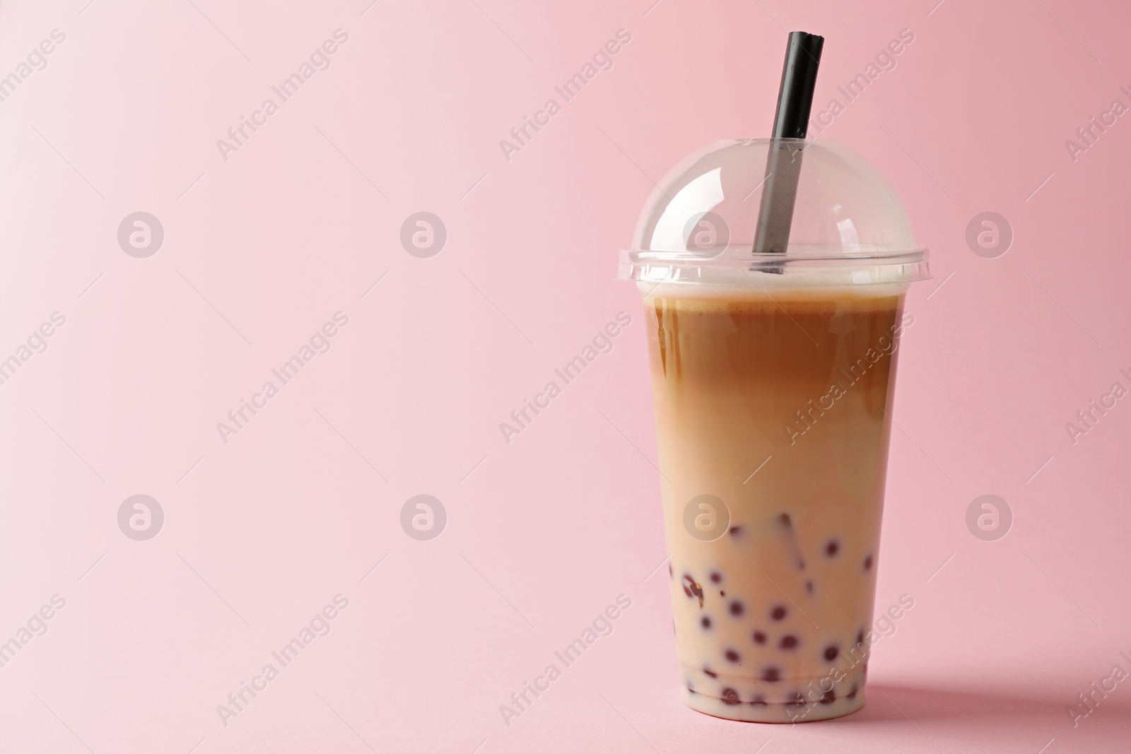 Tasty milk bubble tea in plastic cup on pink background. Space for text Photo of Tasty milk bubble tea in plastic cup on pink background. Space for text