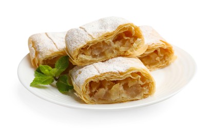 Photo of Pieces of tasty apple strudel with powdered sugar and mint isolated on white