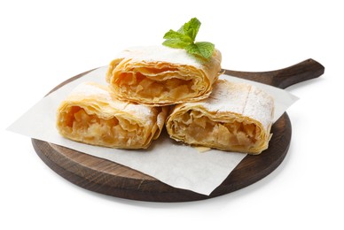 Photo of Pieces of tasty apple strudel with powdered sugar and mint isolated on white
