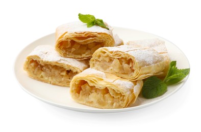 Photo of Pieces of tasty apple strudel with powdered sugar and mint isolated on white