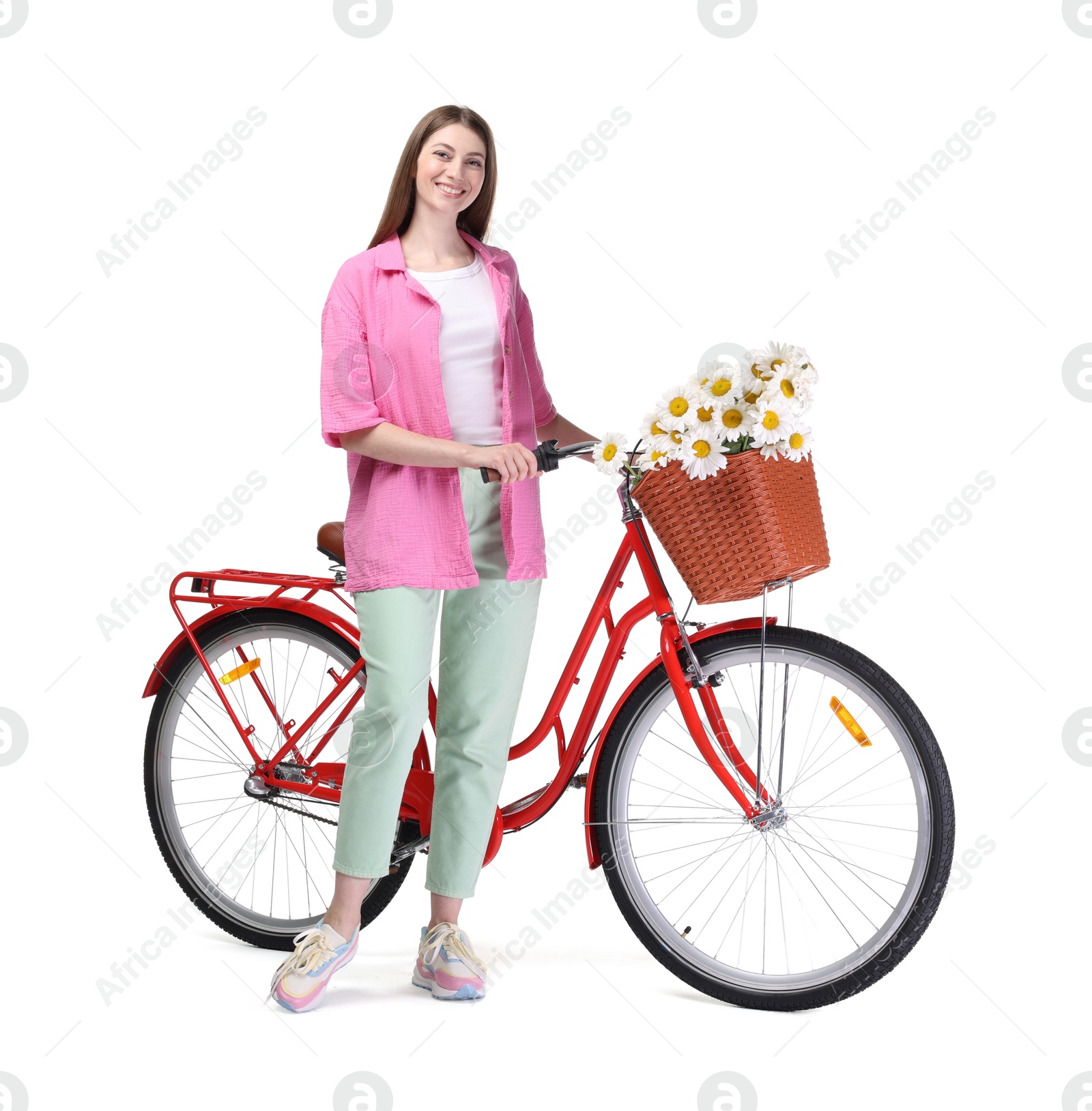 Smiling woman and bicycle with basket of flowers against white background Photo of Smiling woman and bicycle with basket of flowers against white background