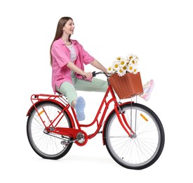 Photo of Smiling woman riding bicycle with basket of flowers against white background