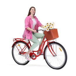 Photo of Smiling woman riding bicycle with basket of flowers against white background