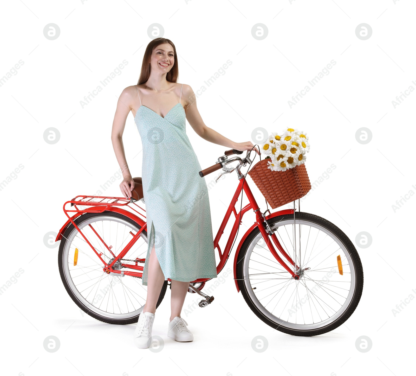 Smiling woman in dress and bicycle with basket of flowers against white background Photo of Smiling woman in dress and bicycle with basket of flowers against white background