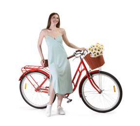 Photo of Smiling woman in dress and bicycle with basket of flowers against white background
