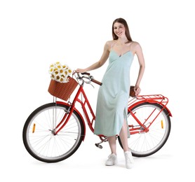 Photo of Smiling woman in dress and bicycle with basket of flowers against white background