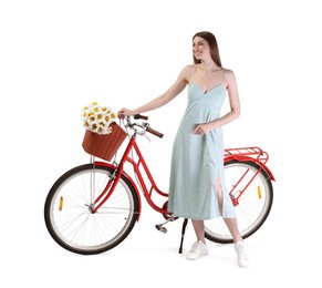 Photo of Smiling woman in dress and bicycle with basket of flowers against white background