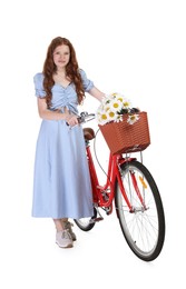 Photo of Beautiful teenage girl in dress and bicycle with basket of flowers against white background