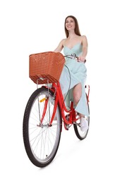 Photo of Smiling woman riding bicycle with basket on white background, low angle view