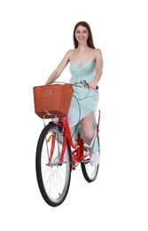 Photo of Smiling woman riding bicycle with basket on white background