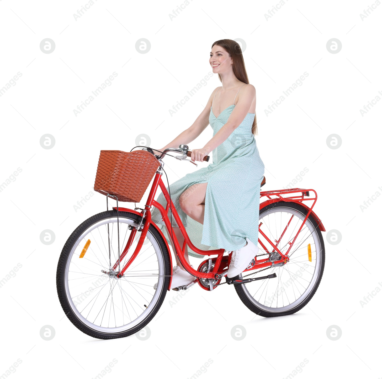 Photo of Smiling woman riding bicycle with basket on white background