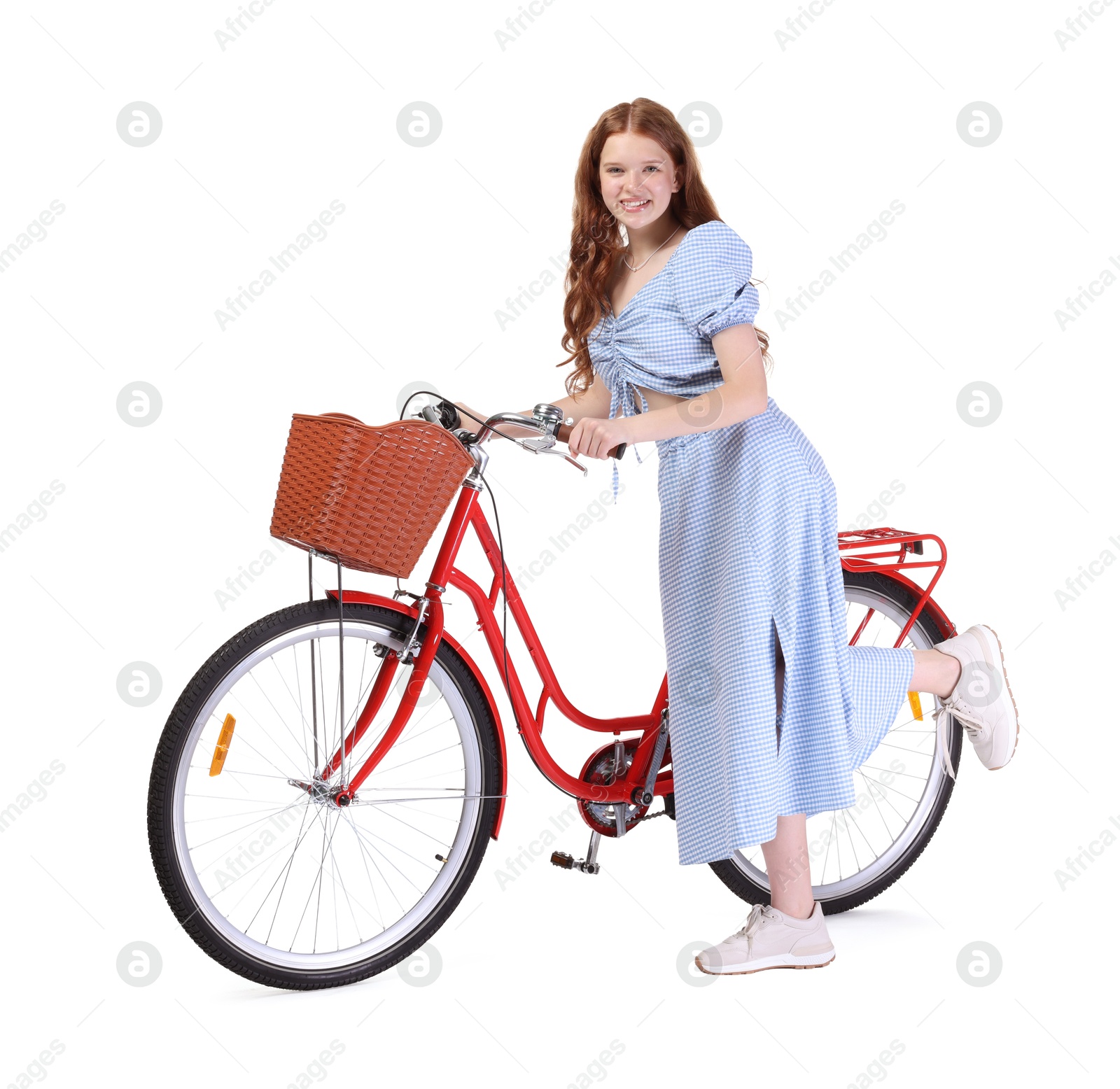 Photo of Smiling teenage girl and bicycle with basket on white background