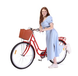 Photo of Smiling teenage girl and bicycle with basket on white background