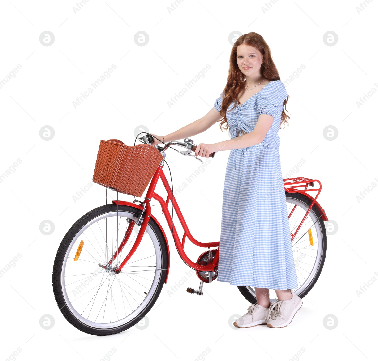 Beautiful teenage girl in dress and bicycle with basket against white background Photo of Beautiful teenage girl in dress and bicycle with basket against white background