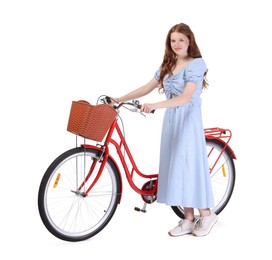 Photo of Beautiful teenage girl in dress and bicycle with basket against white background