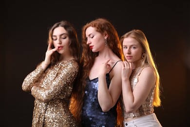 Photo of Beautiful women with different hair colors on dark background