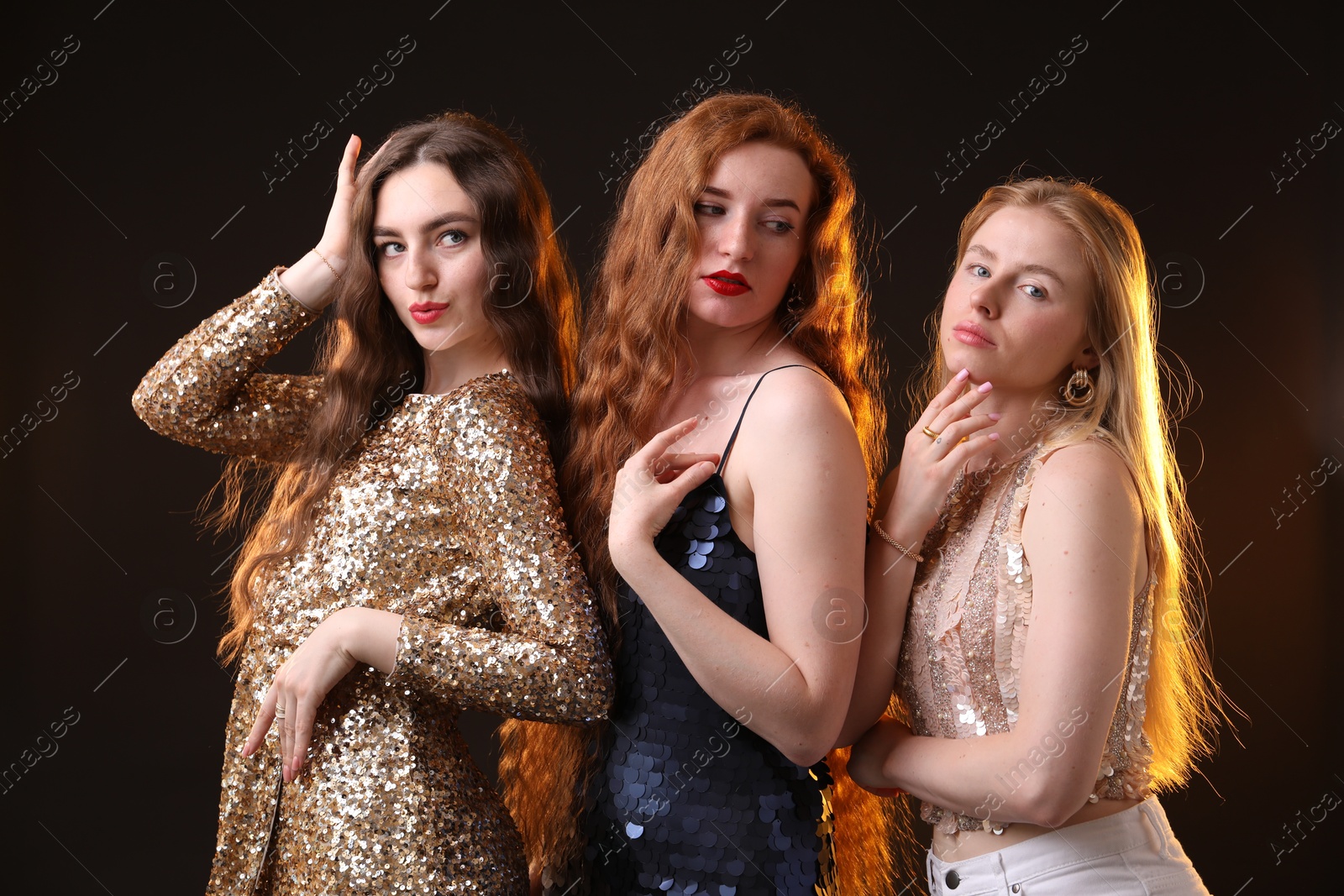 Beautiful women with different hair colors on dark background Photo of Beautiful women with different hair colors on dark background