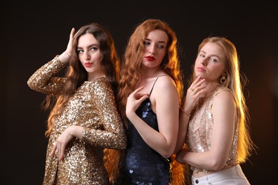 Photo of Beautiful women with different hair colors on dark background