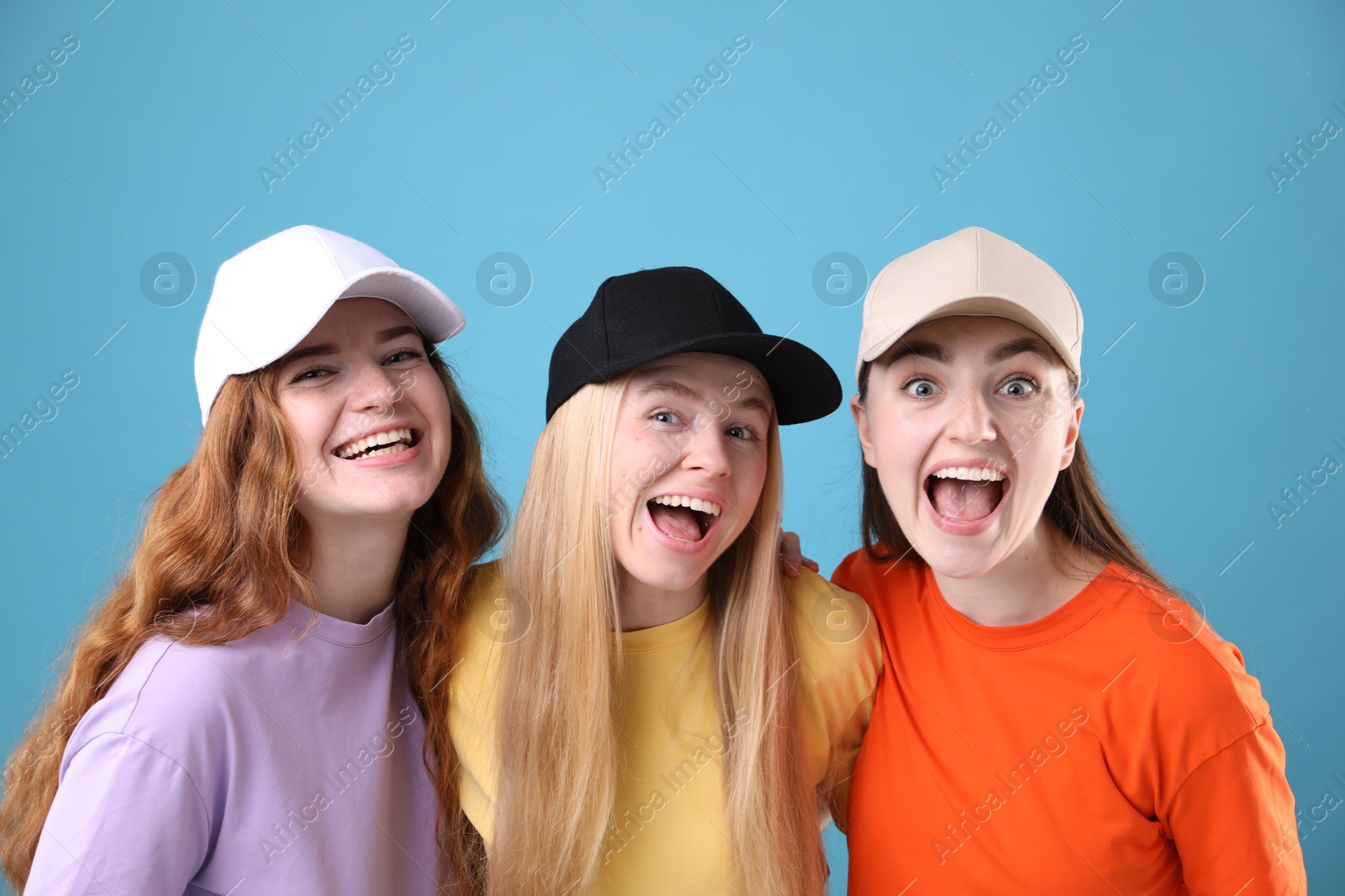 Beautiful women with different hair colors on light blue background Photo of Beautiful women with different hair colors on light blue background