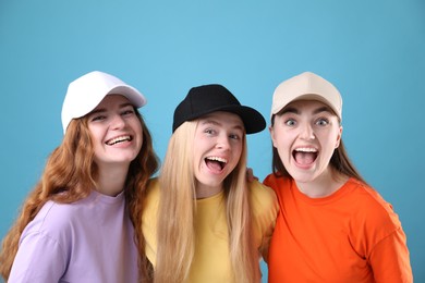 Photo of Beautiful women with different hair colors on light blue background