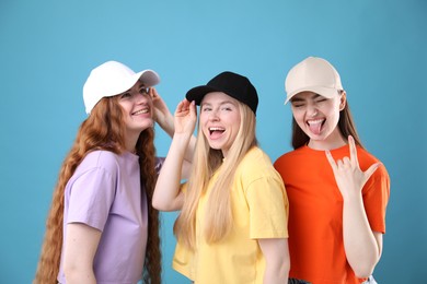 Photo of Beautiful women with different hair colors on light blue background