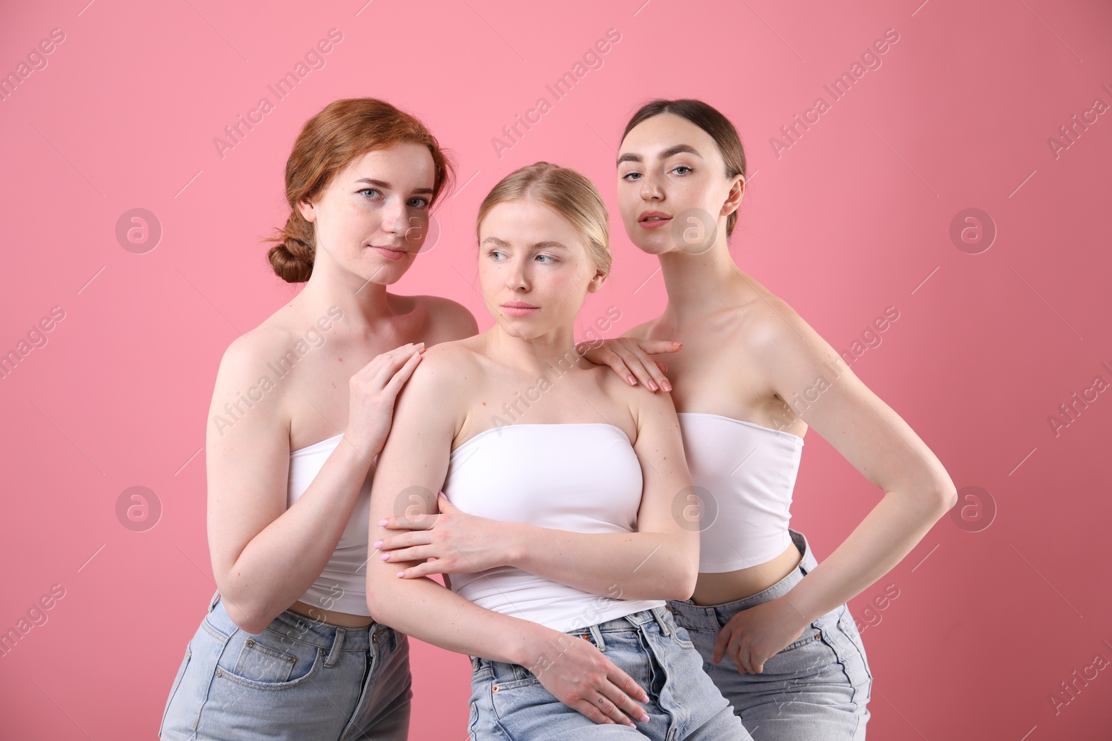 Beautiful women with different hair colors on pink background Photo of Beautiful women with different hair colors on pink background