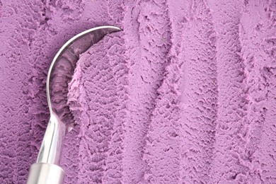 Photo of Tasty blueberry sorbet and metal spoon, top view. Space for text