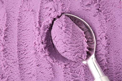 Photo of Tasty blueberry sorbet and metal spoon, top view