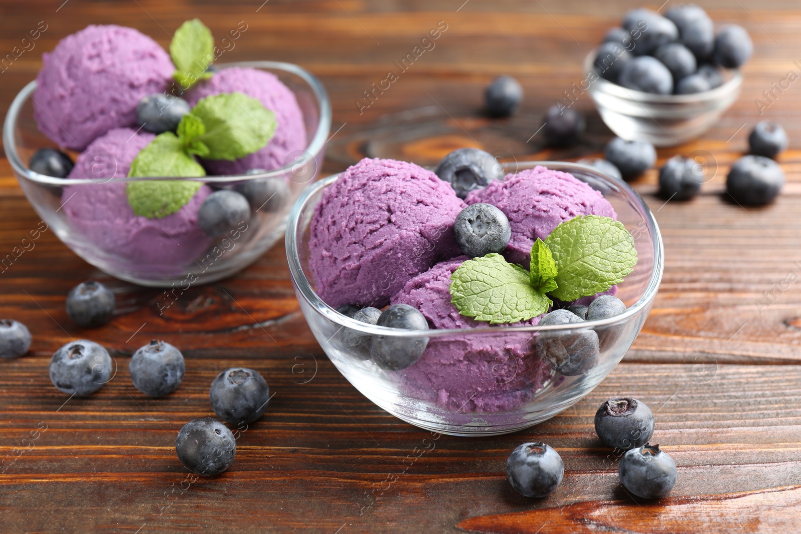 Tasty sorbet with blueberries and mint served on wooden table, closeup Photo of Tasty sorbet with blueberries and mint served on wooden table, closeup