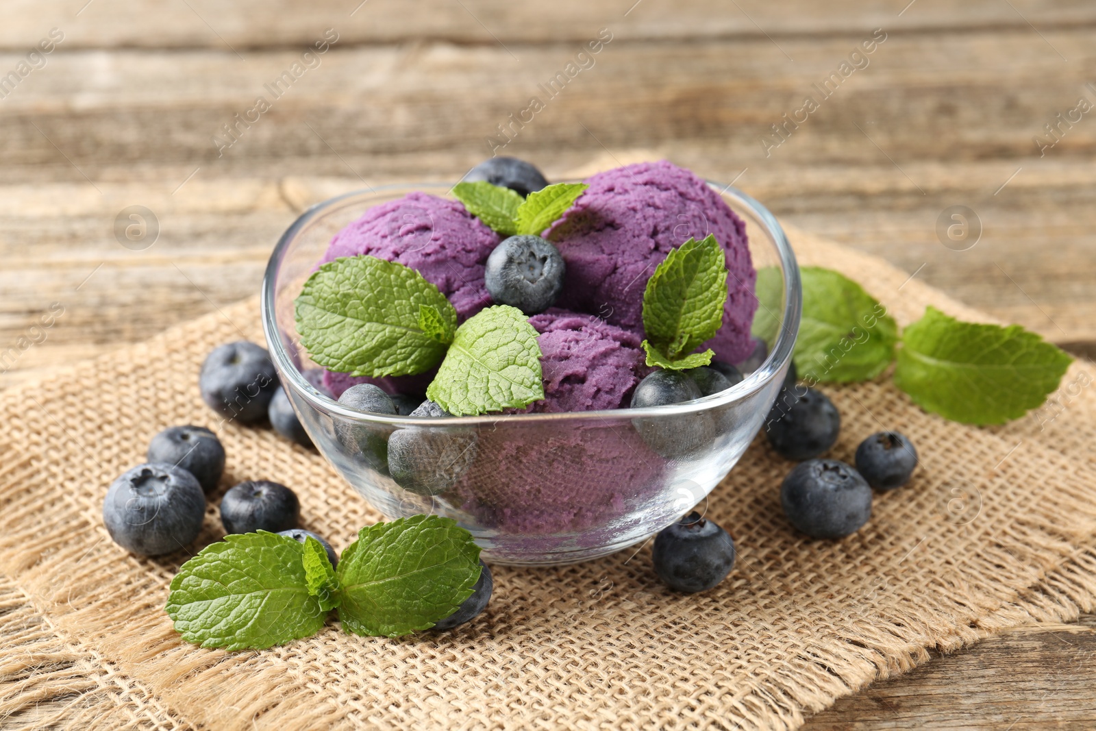 Tasty sorbet with blueberries and mint served on wooden table, closeup Photo of Tasty sorbet with blueberries and mint served on wooden table, closeup