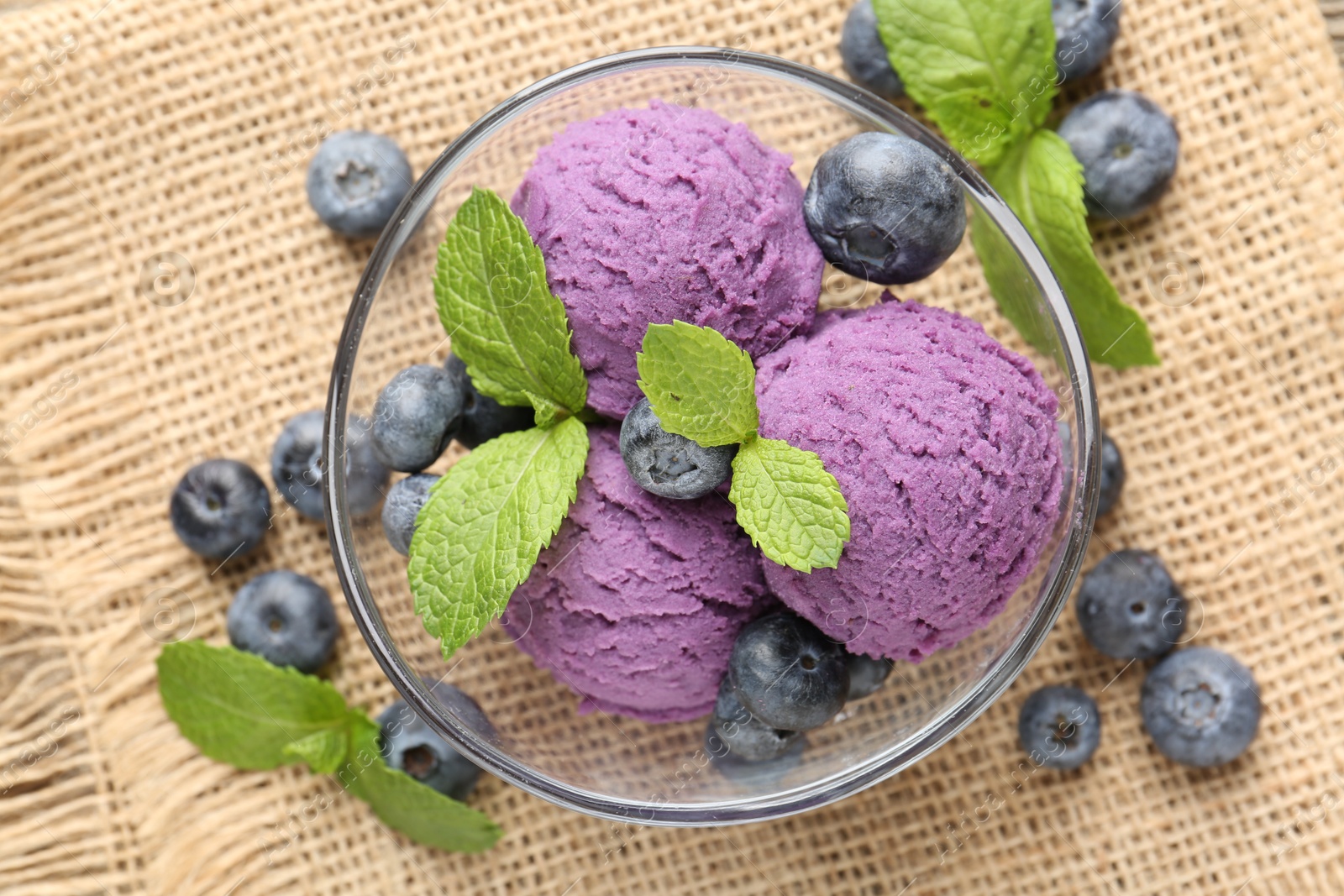 Tasty sorbet with blueberries and mint served on table, flat lay Photo of Tasty sorbet with blueberries and mint served on table, flat lay