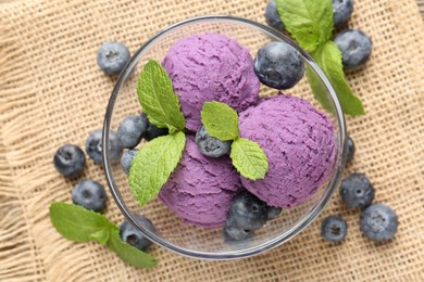 Photo of Tasty sorbet with blueberries and mint served on table, flat lay