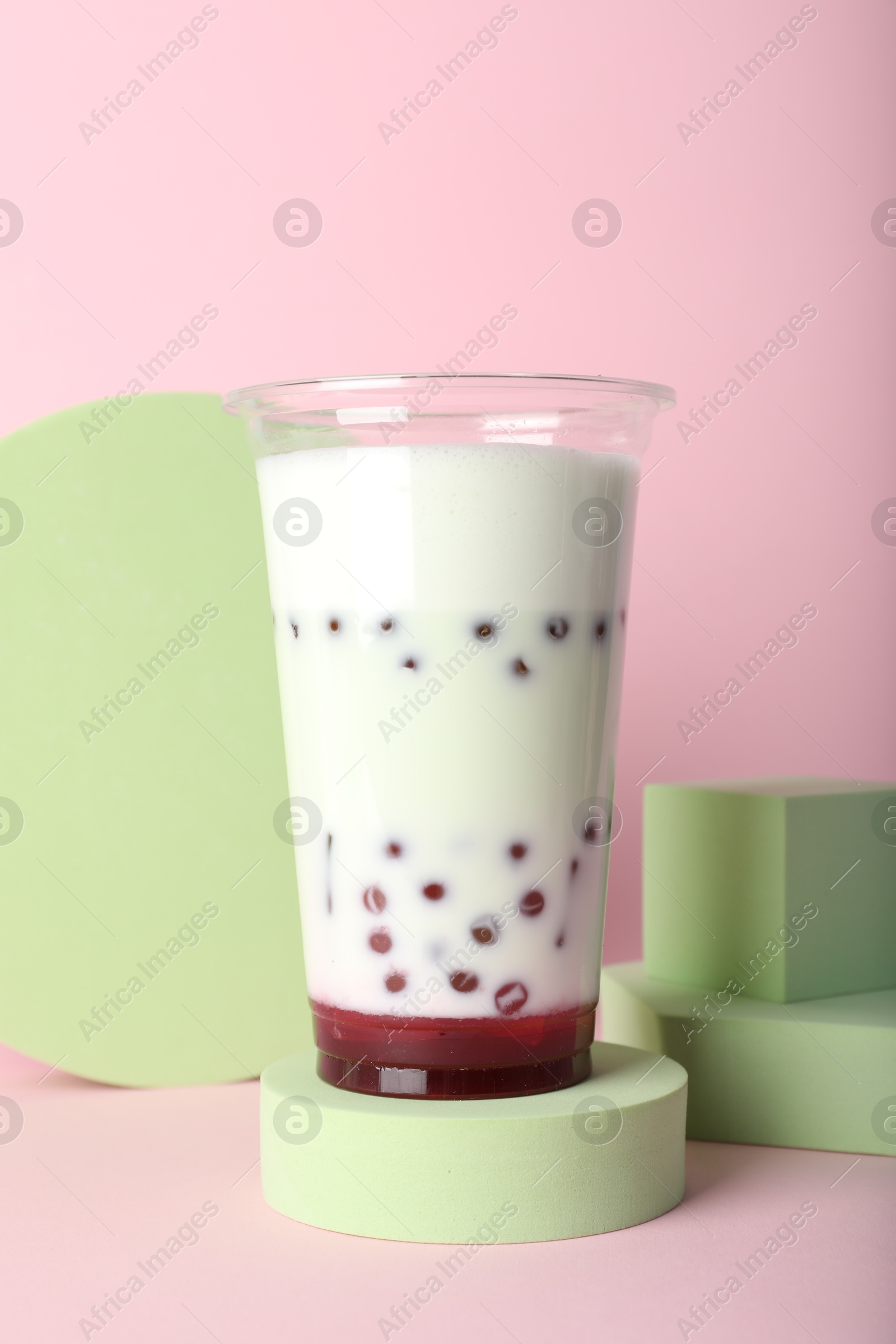 Tasty refreshing bubble tea on pink background Photo of Tasty refreshing bubble tea on pink background