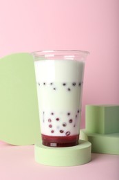 Photo of Tasty refreshing bubble tea on pink background