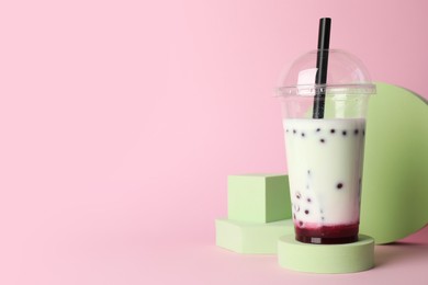 Photo of Tasty refreshing bubble tea on pink background. Space for text