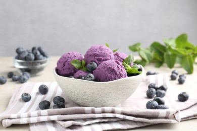 Photo of Tasty sorbet with blueberries and mint on light grey table, closeup
