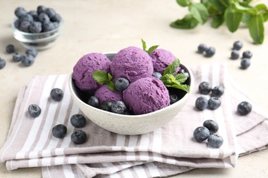 Photo of Tasty sorbet with blueberries and mint on light grey table, closeup
